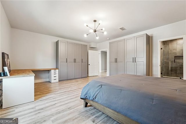 bedroom with connected bathroom, light wood-type flooring, baseboards, a notable chandelier, and visible vents