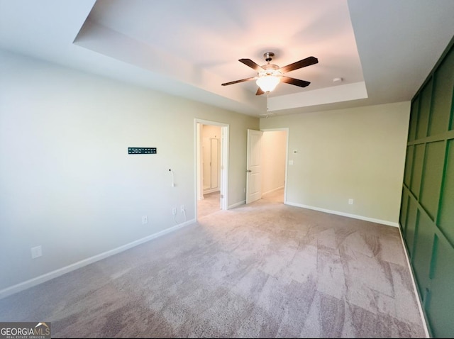 3132 Meadowstone Ln SW, Atlanta, GA 30331 - unfurnished bedroom with a tray ceiling, light colored carpet, and a ceiling fan