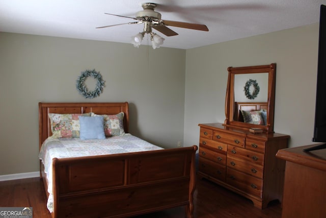 bedroom featuring baseboards, ceiling fan, and dark wood-type flooring