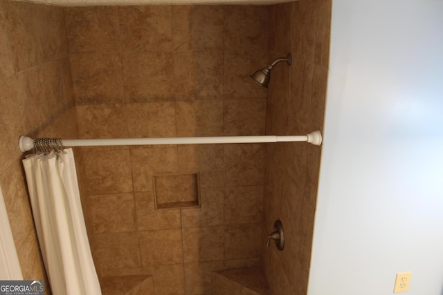 interior details with a tile shower