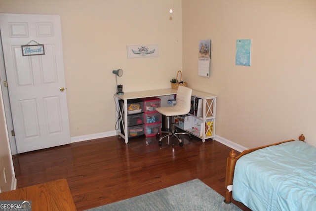 bedroom with baseboards and wood finished floors