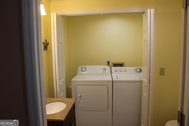 laundry area featuring a sink, washing machine and dryer, and laundry area