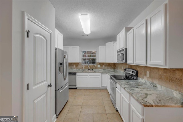 kitchen featuring a sink, white cabinetry, and appliances with stainless steel finishes