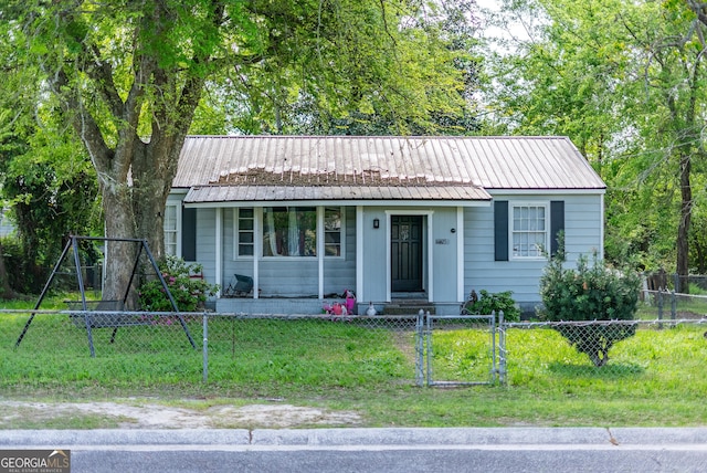 403 Spurgeon St, Waycross, GA 31501 - view of front of property featuring a front yard, a gate, a fenced front yard, and metal roof