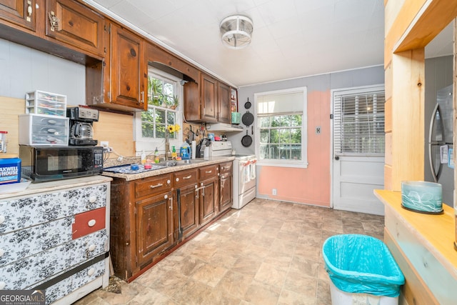 403 Spurgeon St, Waycross, GA 31501 - kitchen featuring a sink, freestanding refrigerator, black microwave, white range with electric cooktop, and baseboards