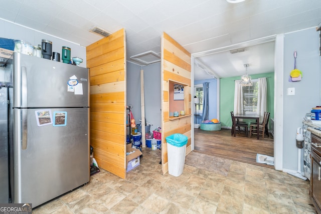 403 Spurgeon St, Waycross, GA 31501 - kitchen with visible vents, stone finish floor, and freestanding refrigerator