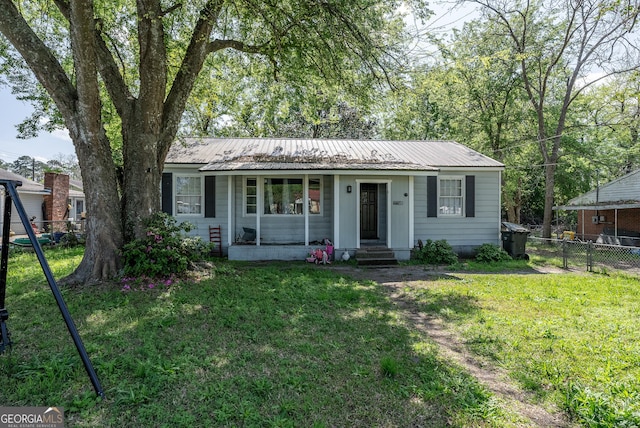 403 Spurgeon St, Waycross, GA 31501 - ranch-style house featuring a front lawn, metal roof, and fence