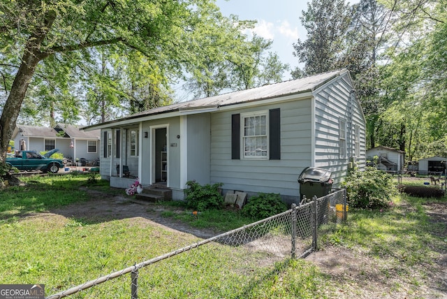403 Spurgeon St, Waycross, GA 31501 - view of front of home with metal roof, fence, a front lawn, and entry steps