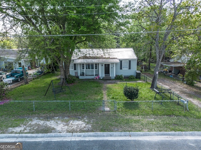403 Spurgeon St, Waycross, GA 31501 - view of front of home with a gate, a fenced front yard, metal roof, and a front yard