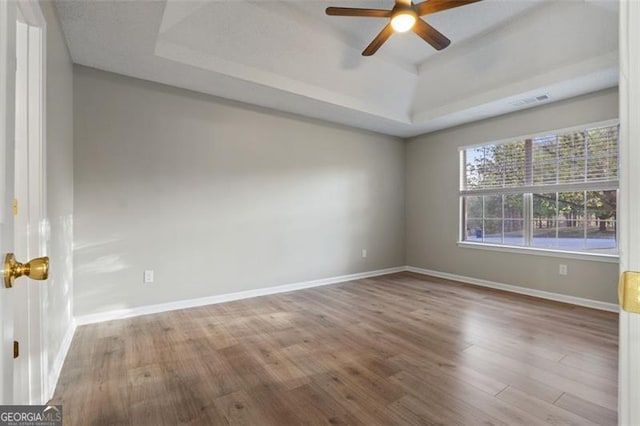 4625 Thermal Ct, Douglasville, GA 30135 - empty room with ceiling fan, a raised ceiling, baseboards, wood finished floors, and visible vents