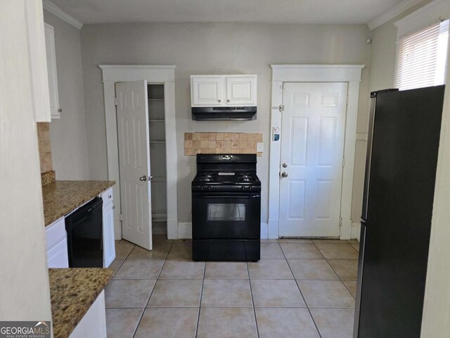 kitchen featuring ornamental molding, under cabinet range hood, white cabinetry, black appliances, and light tile patterned floors