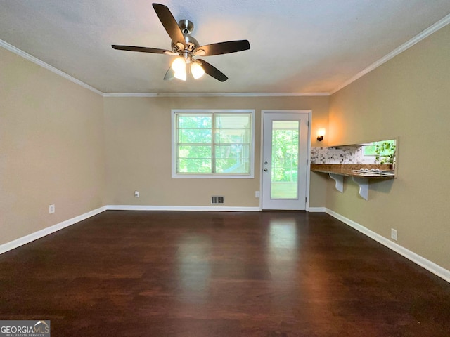 unfurnished living room with dark wood finished floors, ceiling fan, baseboards, and crown molding