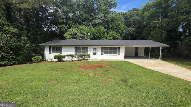 ranch-style home with driveway, a carport, and a front lawn