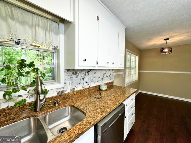 kitchen featuring a sink, dishwasher, decorative backsplash, white cabinets, and a textured ceiling