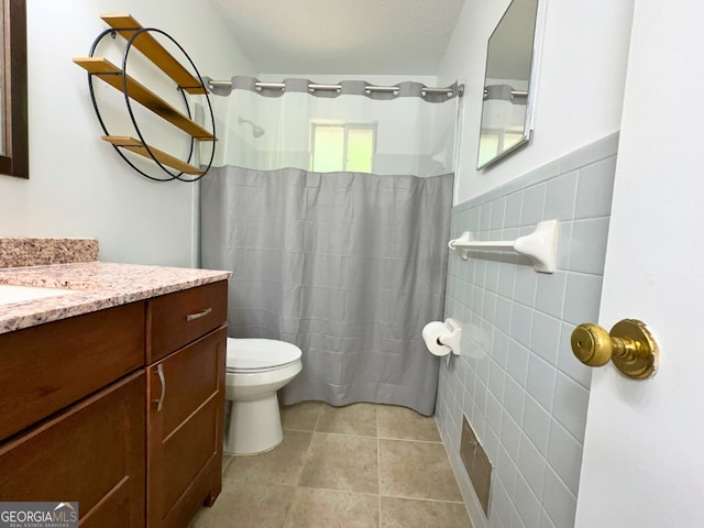 bathroom featuring tile walls, vanity, toilet, tile patterned flooring, and a shower with shower curtain