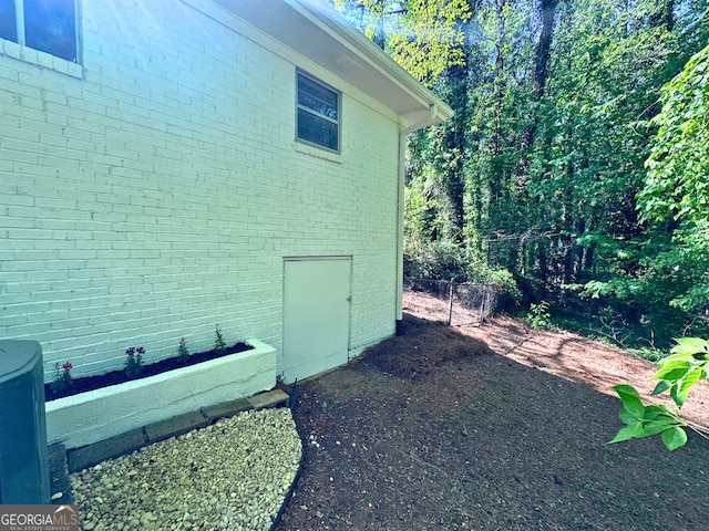 view of side of property with brick siding