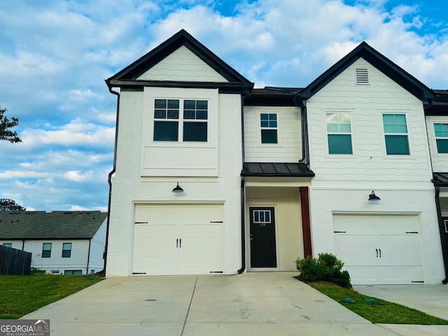 124 Auburn Run Ln, Auburn, GA 30011 - view of property featuring brick siding, driveway, a garage, and a standing seam roof