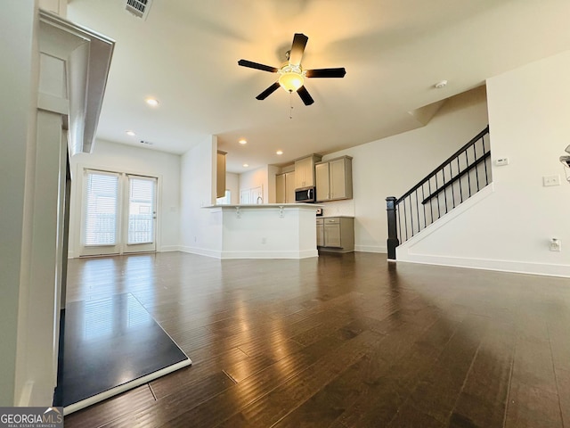 124 Auburn Run Ln, Auburn, GA 30011 - unfurnished living room with dark wood-style floors, ceiling fan, baseboards, stairs, and recessed lighting