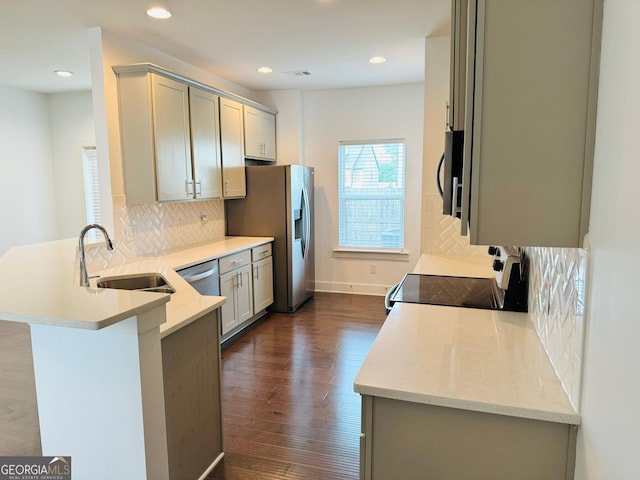 124 Auburn Run Ln, Auburn, GA 30011 - kitchen featuring a sink, range with electric stovetop, a peninsula, stainless steel fridge with ice dispenser, and tasteful backsplash