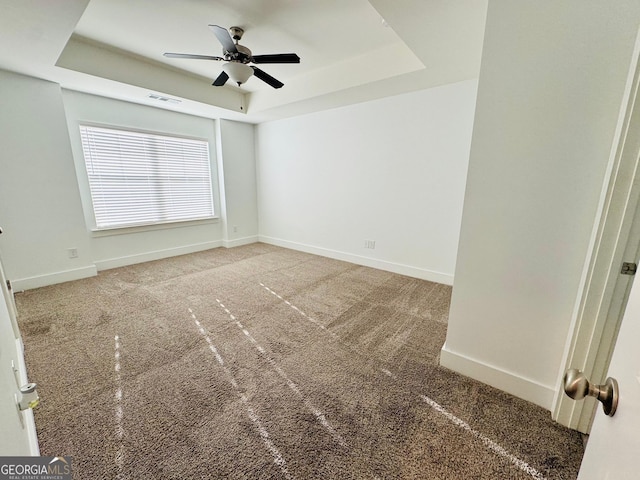 124 Auburn Run Ln, Auburn, GA 30011 - empty room featuring a raised ceiling and carpet flooring