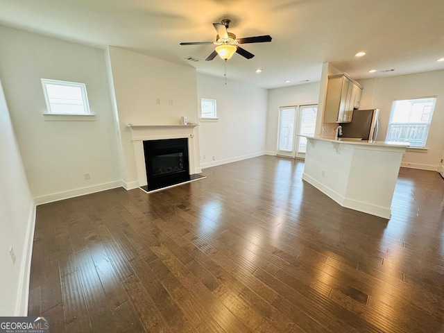 124 Auburn Run Ln, Auburn, GA 30011 - unfurnished living room featuring plenty of natural light, a fireplace with raised hearth, ceiling fan, and recessed lighting