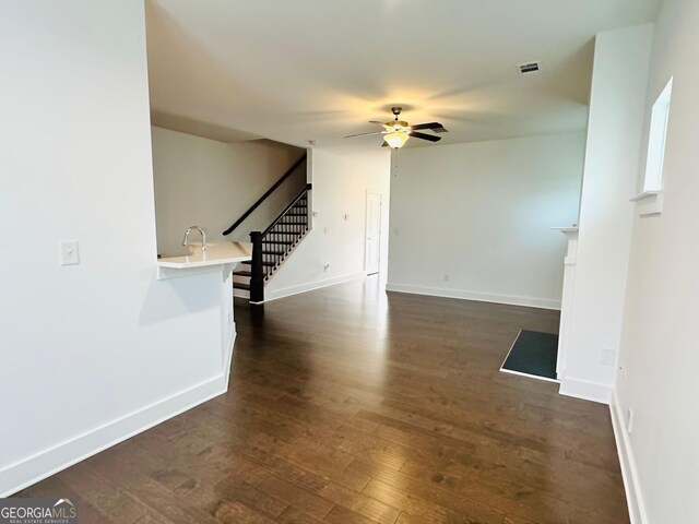 124 Auburn Run Ln, Auburn, GA 30011 - unfurnished living room with a ceiling fan, stairway, dark wood finished floors, and baseboards