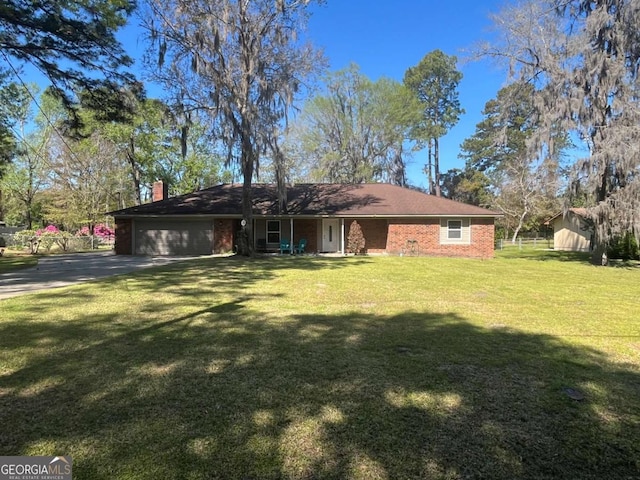 411 Woodland Dr, Hinesville, GA 31313 - view of front of property with a garage, a chimney, concrete driveway, brick siding, and a front lawn