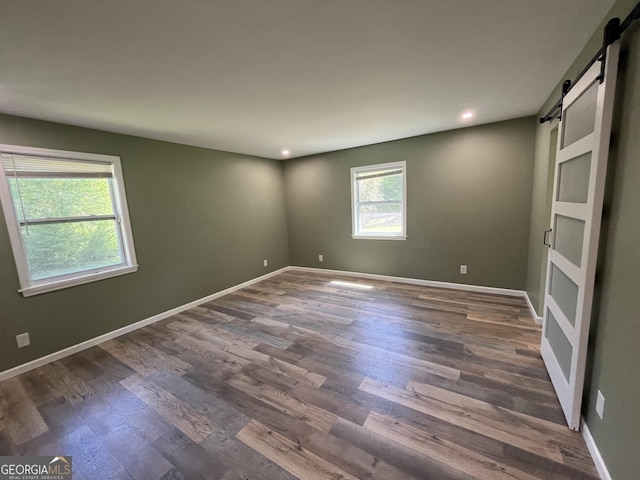 411 Woodland Dr, Hinesville, GA 31313 - unfurnished room with baseboards, recessed lighting, a barn door, and dark wood finished floors