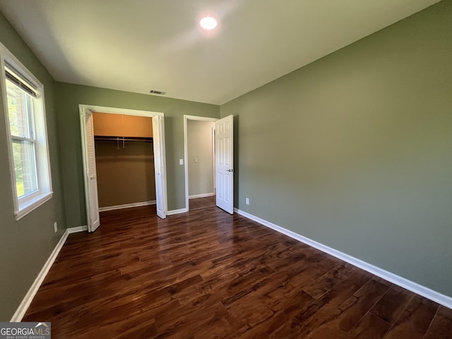 411 Woodland Dr, Hinesville, GA 31313 - unfurnished bedroom featuring visible vents, baseboards, a closet, and dark wood finished floors