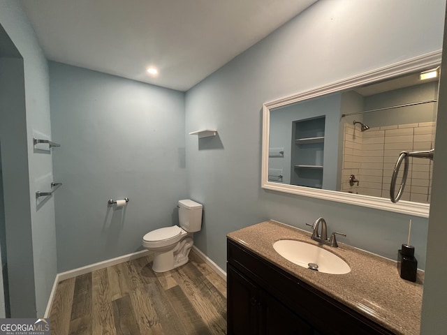 411 Woodland Dr, Hinesville, GA 31313 - full bath with walk in shower, baseboards, toilet, vanity, and wood finished floors