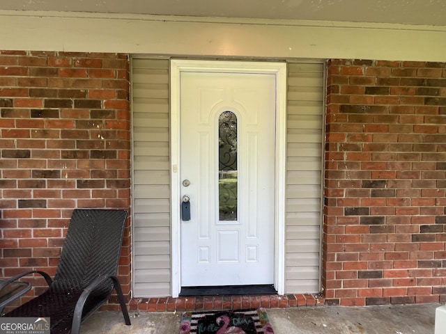 411 Woodland Dr, Hinesville, GA 31313 - view of exterior entry featuring brick siding