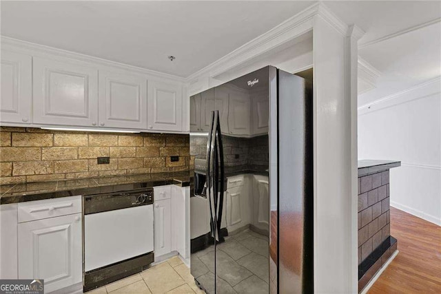 kitchen featuring dishwasher, white cabinetry, crown molding, and black fridge