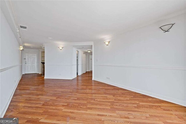 spare room with light wood-style flooring and visible vents
