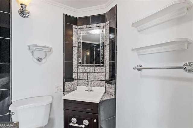 bathroom with crown molding, toilet, and vanity