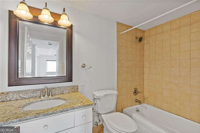 full bathroom with toilet, vanity, and shower / tub combination