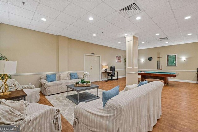 living room with ornate columns, visible vents, wood finished floors, and billiards