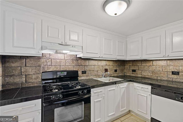 kitchen featuring under cabinet range hood, a sink, dark countertops, black gas stove, and white dishwasher