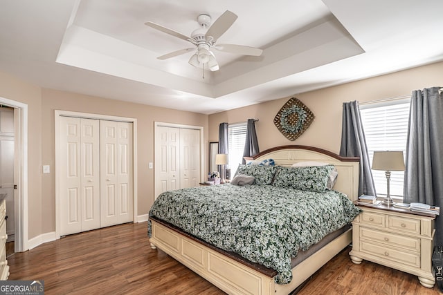 37 Covered Springs Dr NE, Rome, GA 30165 - bedroom featuring baseboards, multiple closets, wood finished floors, and a raised ceiling