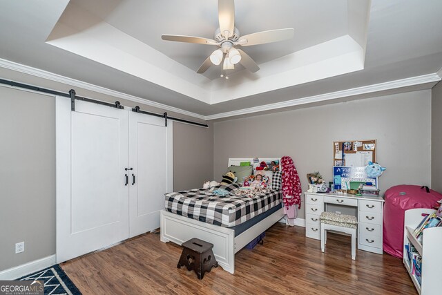 37 Covered Springs Dr NE, Rome, GA 30165 - bedroom featuring a barn door, dark wood-style floors, crown molding, and a raised ceiling