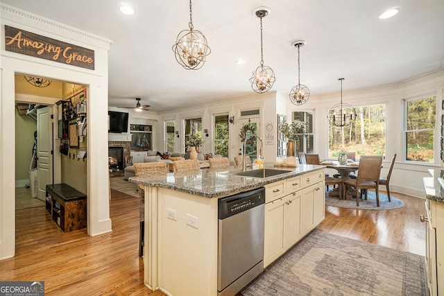 3227 Aviary Ct NW, Acworth, GA 30101 - kitchen with dishwasher, a sink, a chandelier, a stone fireplace, and a kitchen island with sink