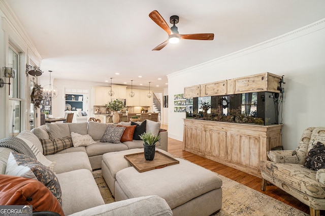 3227 Aviary Ct NW, Acworth, GA 30101 - living area with ceiling fan, light wood-type flooring, ornamental molding, recessed lighting, and a chandelier