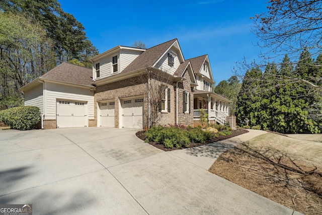 3227 Aviary Ct NW, Acworth, GA 30101 - view of side of property with concrete driveway, a porch, an attached garage, brick siding, and a shingled roof