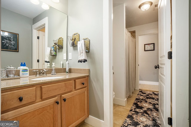 3227 Aviary Ct NW, Acworth, GA 30101 - full bath featuring vanity, toilet, tile patterned floors, a shower with shower curtain, and baseboards