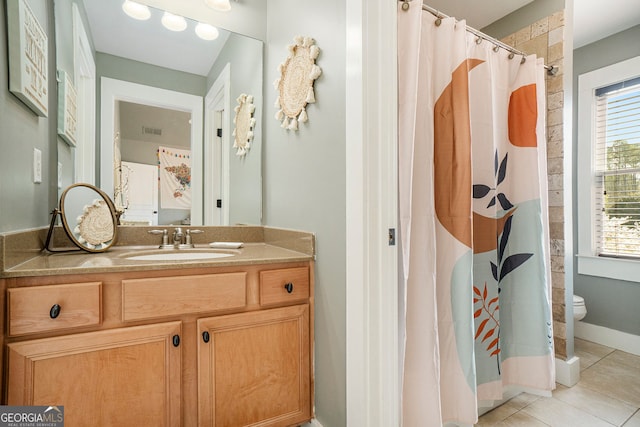 3227 Aviary Ct NW, Acworth, GA 30101 - bathroom featuring toilet, vanity, tile patterned flooring, and healthy amount of natural light