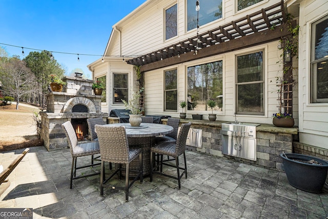 3227 Aviary Ct NW, Acworth, GA 30101 - view of patio / terrace with an outdoor stone fireplace, exterior kitchen, outdoor dining space, and a pergola