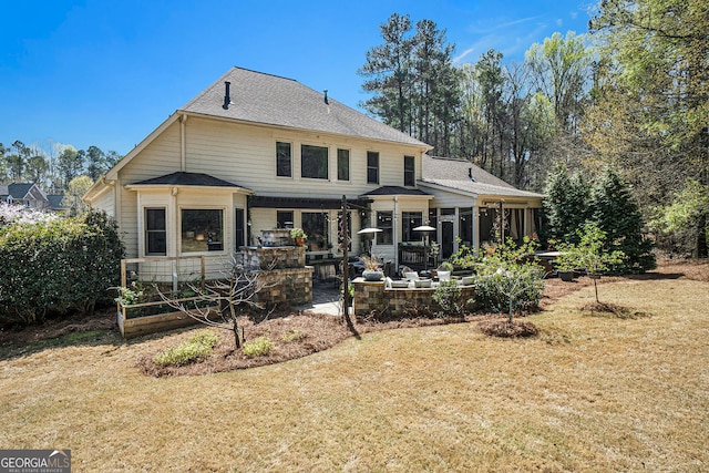 3227 Aviary Ct NW, Acworth, GA 30101 - back of house featuring a sunroom, a lawn, a patio area, and a shingled roof