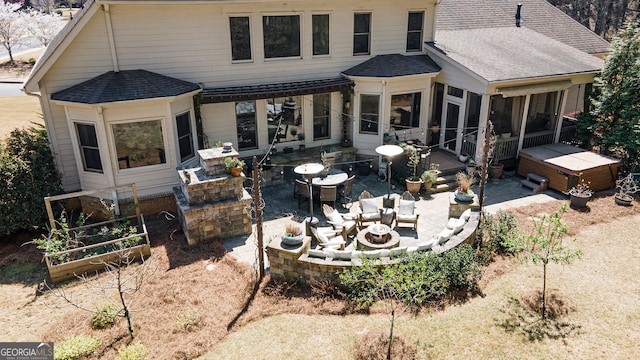 3227 Aviary Ct NW, Acworth, GA 30101 - rear view of property with a patio area, roof with shingles, a hot tub, a sunroom, and an outdoor living space with a fire pit