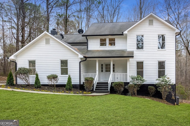 traditional home with a front lawn, a porch, and a shingled roof