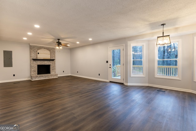 unfurnished living room with ceiling fan with notable chandelier, electric panel, visible vents, and a textured ceiling