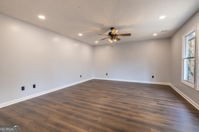 spare room with a ceiling fan, recessed lighting, and dark wood-type flooring